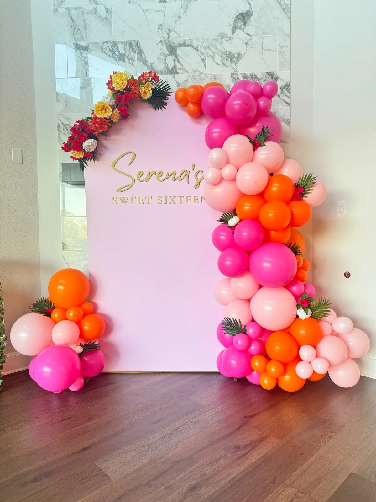 Pink Sweet Sixteen backdrop with organic balloon garland